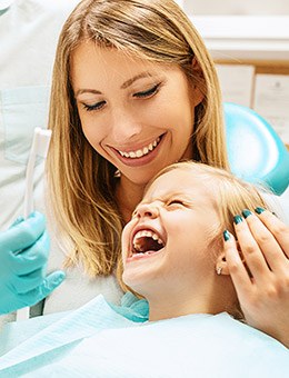 Mother and daughter in exam chair for children's dentistry checkup