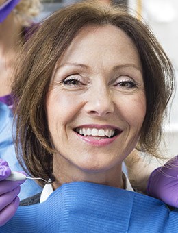 Woman smiling after tooth colored filling restoration