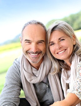 Happy senior couple enjoying benefits of All-on-4 implants