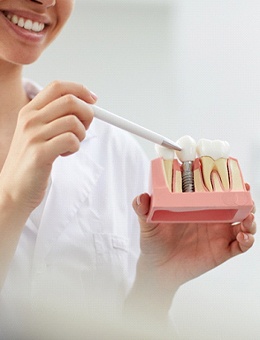Dental professional explaining different types of implant treatment