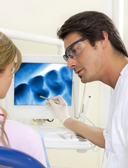 Dentist explaining post-op instructions in Murphy to a patient