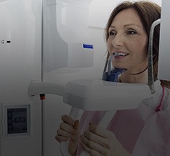 Woman receiving 3 D cone beam scans of her mouth and jaw