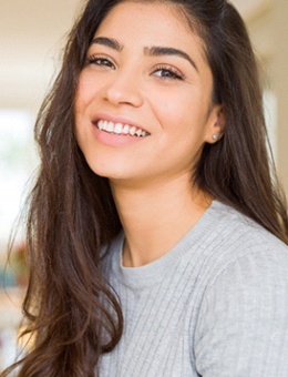 young woman smiling after getting veneers in Murphy