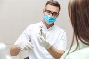 Dentist discussing dental implant