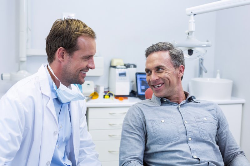 man discussing dental myths with dentist